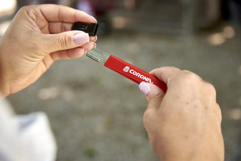 Person using handheld garden tool sharpener with tungsten carbide blade on pruning shears
