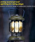 Led Camping Lantern With Rechargeable Battery And Retro Metal Construction shown lit in rainy outdoor setting