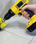 Close-up of hand using Drill Brush Scrubber Set With Nylon Bristles on tiles, featuring 2, 3.5, and 4 inch heads for cleaning.