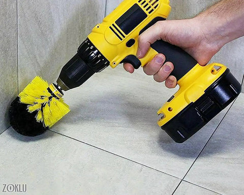Close-up of hand using Drill Brush Scrubber Set With Nylon Bristles on tiles, featuring 2, 3.5, and 4 inch heads for cleaning.
