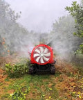 Heavy Duty Remote Control Spray Vehicle And Crawler Sprayer With Tracked Machine Design spraying in an orchard amidst citrus trees.
