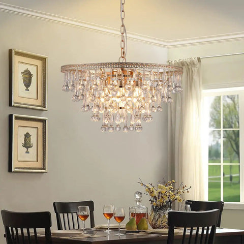 Gold Crystal Raindrop Chandelier Pendant Light For Dining And Living Rooms over a dining table with sparkling crystal drops.