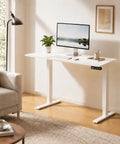 Compact Electric Standing Desk With Single Motor And One Touch Lift System set up in a cozy home office with a white steel frame.