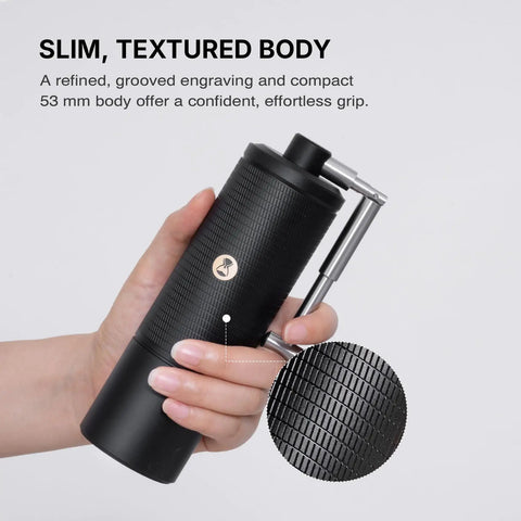 Person holding C5 Pro Manual Coffee Grinder With S2C 042 III Stainless Steel Conical Burrs And 0.031mm Per Click Precision All Metal Portable Hand Coffee Mill in Black, showcasing textured body for grip.