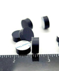 One Half Inch Round Silicone Rubber Bumper Feet Three Sixteenths Of An Inch Thick Adhesive Backed Spacer Pads with ruler