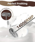 Close-up of handheld milk frother cordless electric foam maker with stainless steel whisk frothing milk at 14000 RPM