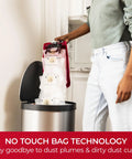Hassle Free Bagged Upright Vacuum With No Touch Auto Dump, user disposing of sealed dirt bags into trash can.