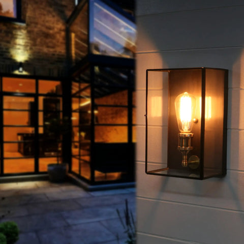 Solid Brass Outdoor Wall Light Fixture With Clear Tempered Glass Waterproof Outdoor Sconce For Front Porch Garage Garden Patio Staircase Balcony Built Tough And Ready Door Lantern Design lit at night on wall.