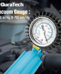 Close-up of blue DuraTech handheld vacuum brake bleeder gauge.