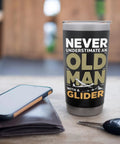 Glider Pilot Dad Insulated Stainless Steel Tumbler on table with 'Never Underestimate an Old Man with a Glider' text.