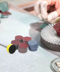 Get Your Hands On This Awesome Set Of 100pcs Sanding Discs With Grits From 100 To 3000 For Smooth Drilling And Shiny Finishes That Last with assorted discs arranged.