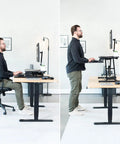 Man at desk using height adjustable 32 inch desk converter with sit to stand quick elevation tabletop dual monitor riser in office