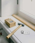 Heavy Duty Stainless Steel Sliding Door Rollers 4 Pack Featuring Precision Ball Bearings 23mm Axle on a windowsill with tools.