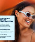 Woman wearing Experience 2 Ear Plugs For Concerts And Festivals With High Fidelity Sound And 17dB Noise Reduction, smiling at event