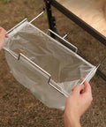 Person assembling Sturdy Stainless Iron Trash Bag Holder Rack For Hanging Use Desktop Or Campin Dustbin Cage Garbage Bag Holder