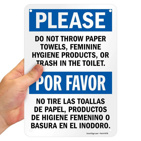 Please Do Not Flush Paper Towels Or Trash In The Toilet Bilingual Sign 7x10 plastic HDPE sign held in hand