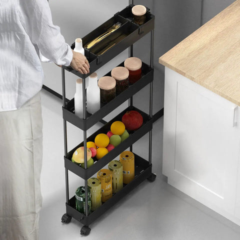 Person using Slim Four Tier Storage Cart Rolling Organizer for kitchen with snacks and bottles, black frame, narrow gap.