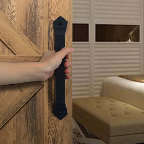 Person holding Barn Door Handle Set Eleven And One Eighth Inch Built Tough Rustic Cast Iron Gate Pulls In Black on wooden door