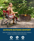 Woman seated in Freestyle Rocker Outdoor Rocking Chair With Beverage Holder Portable Camp And Patio Rocker by a campfire.