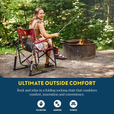 Woman seated in Freestyle Rocker Outdoor Rocking Chair With Beverage Holder Portable Camp And Patio Rocker by a campfire.