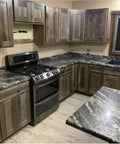 Kitchen featuring Buckwild Aging Wood Stain Drops Real Barnwood Charm On Any Deck Making Weathering A Hassle Free Experience with gray brown counters.