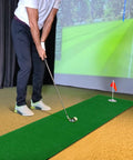 Man practicing on Indoor Outdoor Putting Green Mat That Feels Like Real Turf Pro Grade Non Slip Practice Turf For Home Office Garage Game Changer For Casual And Competitive Golfers