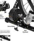 Close-up of All Weather Indoor Bike Trainer Stand with Magnetic Resistance showing flywheels and drive roller