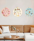 Three embroidery hoops with colorful pre-printed patterns on a living room wall. Beginner Embroidery And Cross Stitch Kit For Adults 3 Pack