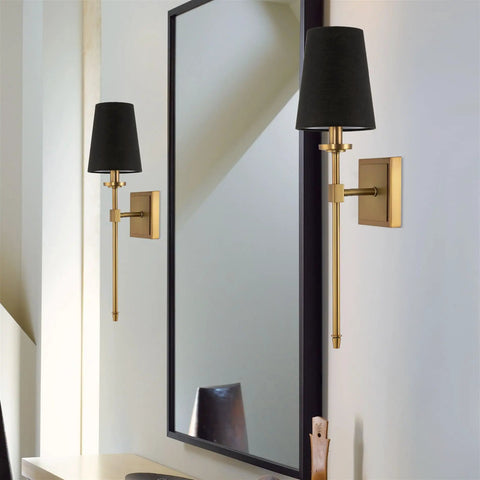 Dope Mid Century Modern Wall Sconce With Black Linen Cone Shade And Warm Brass Finish in bathroom next to mirror