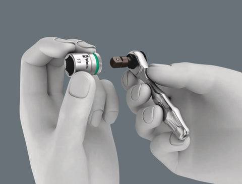 Hands holding a ratchet and socket from Kraftform Kompakt Zyklop Mini 27 Piece Ratchet Set Built For Tight Spaces With Drop Forged Full Steel Construction