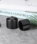 4 Pack Trailer Bearing Dust Caps 1.98 Inch Rubber Wheel Hub Caps shown on a table with books in background.