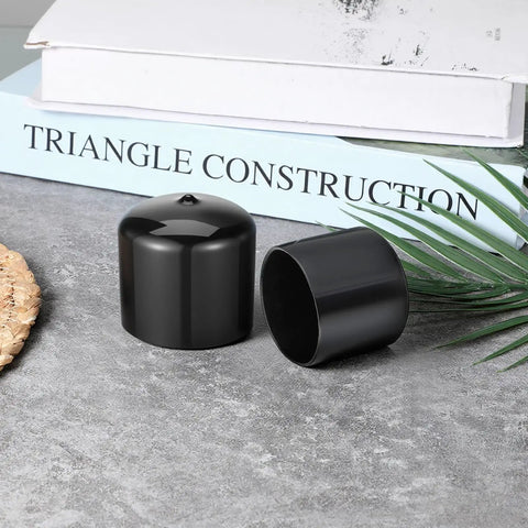 4 Pack Trailer Bearing Dust Caps 1.98 Inch Rubber Wheel Hub Caps shown on a table with books in background.