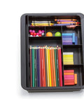Slick Expandable Drawer Organizer Tray With Adjustable Width And Removable Dividers For Hustle Ready Desk Organization In Smooth Recycled Black Plastic Finish filled with colored pencils, crayons, and supplies.