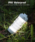 Rechargeable Camping Lantern With RGB Light 550LM Brightness Waterproof Tent Light lying on wet grass