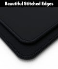Close-up of stitched edges on Massive 60 By 30 Inch Gaming Desk Mat With 4mm Thick Cloth Surface, Non Slip Rubber Base.