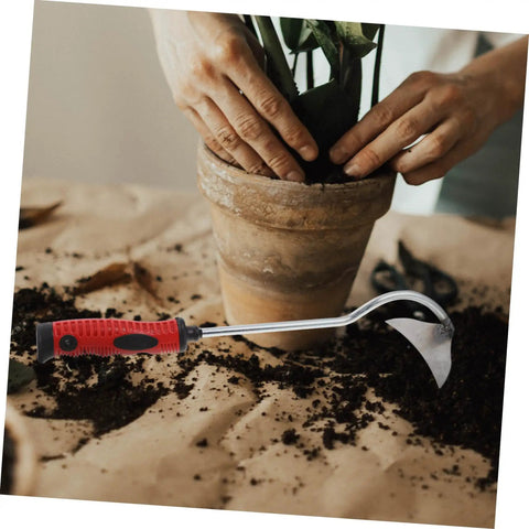 Lightweight Garden Hand Hoe Weeding Tool With Non Slip Handle beside a potted plant and soil in a gardening scene.