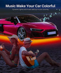 Lit Underglow Car Lights Kit With 16 Million RGB Colors illuminating a red car on beach with people relaxing nearby.