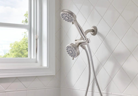 Brushed Nickel Five-Function Shower Head With Handheld Showerhead, 3.75 Inch Spray Head, 60 Inch Hose mounted on white tiled wall