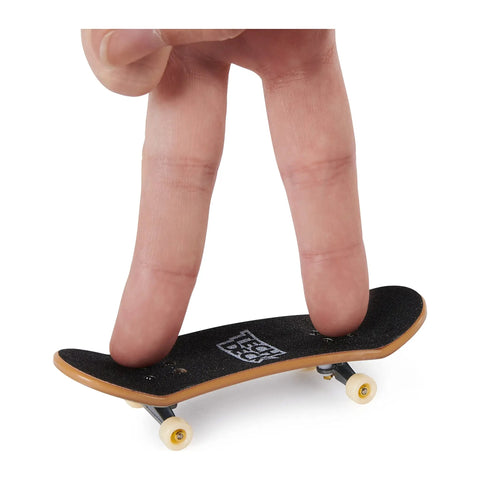 Fingerboard Bonus Pack With Six Real Graphic Mini Skateboards, customizable set with fingers demonstrating play on mini board.