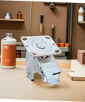 Heavy Duty Swivel Caster Bracket With Parking Brake, Four Inch Steel Rotating Wheel Frame, close-up view on a workbench.