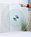 Hand holding Heavy Duty Round Tempered Glass Turntable 24 To 33 Inch Lazy Susan for kitchen tabletop display.