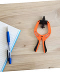 Phone Screen Opening Tool With Suction Cup Pliers For Easy DIY Repairs on a wooden surface next to a notebook and pen