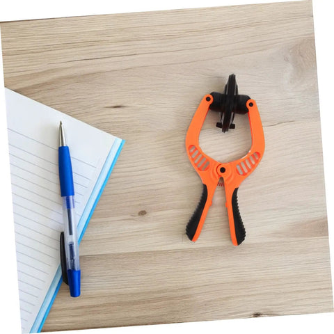 Phone Screen Opening Tool With Suction Cup Pliers For Easy DIY Repairs on a wooden surface next to a notebook and pen