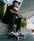 Man sitting outdoors wearing Pro X Inline Skates For Men With Molded Boot Comfort, Anatomical Sublimated Lining, Gray 44.5