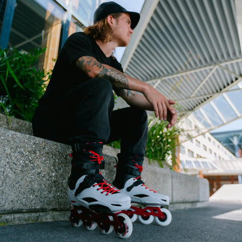 Man sitting outdoors wearing Pro X Inline Skates For Men With Molded Boot Comfort, Anatomical Sublimated Lining, Gray 44.5