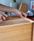 Person installing Rock Solid 6 Pack 15.7 Inch Wooden Drawer Slides on a wooden drawer for cabinet upgrade.