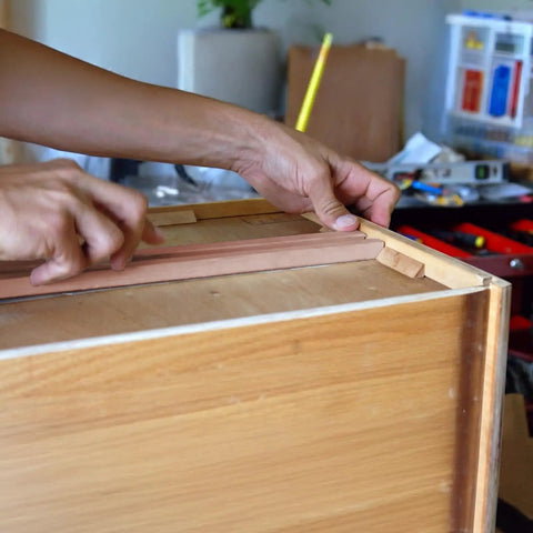 Person installing Rock Solid 6 Pack 15.7 Inch Wooden Drawer Slides on a wooden drawer for cabinet upgrade.