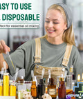 Woman using Premium Disposable Plastic Transfer Pipettes 1ml, 120-Pack Clear Graduated Eye Droppers for essential oils.