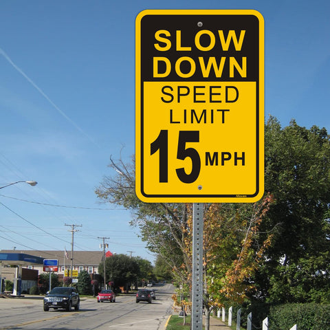 Street view with Slow Down Speed Limit 15 MPH Sign; 12x18 inch reflective aluminum traffic sign displayed on roadside pole.