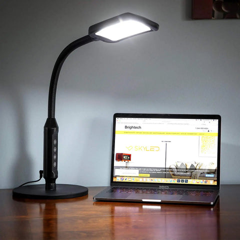 2 In 1 LED Floor And Desk Lamp With Adjustable Height And Gooseneck next to laptop on wooden desk